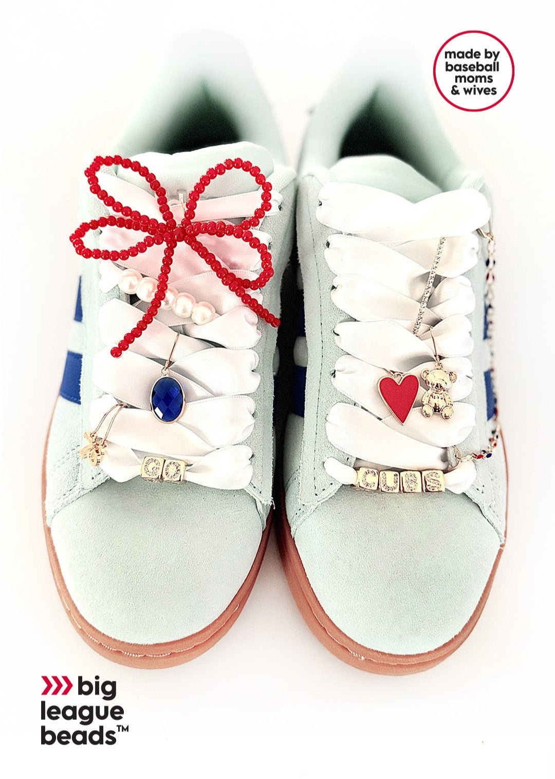 Pair of white sneakers with decorative laces and charms on a white background, featuring Big League Beads branding.