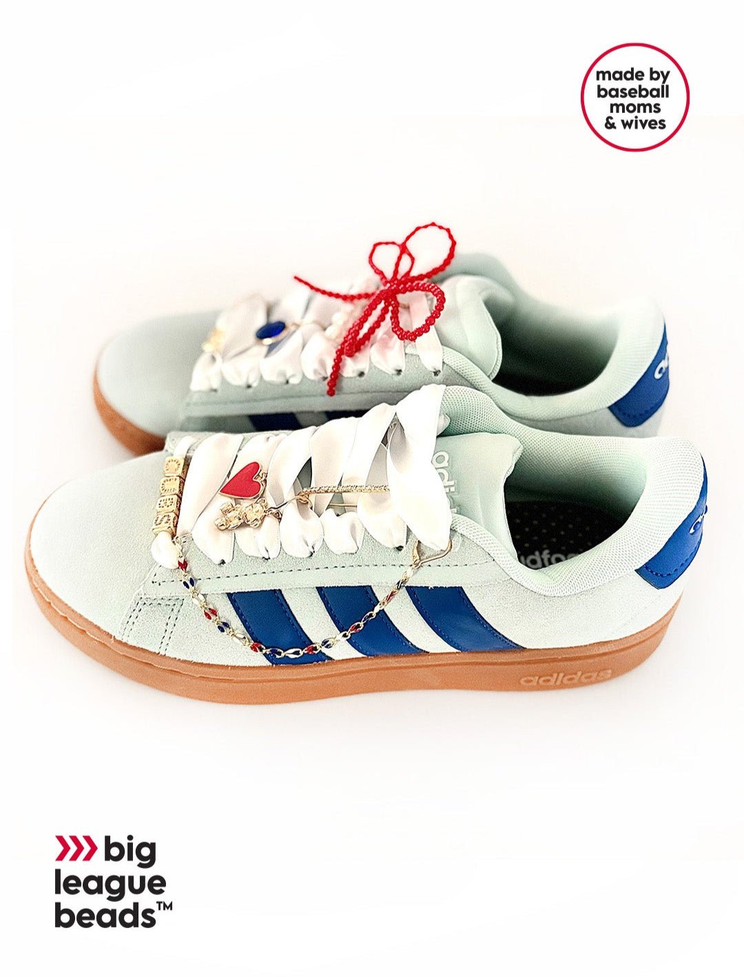 White sneakers with blue stripes and red laces on a white background, featuring 'big league beads' branding.