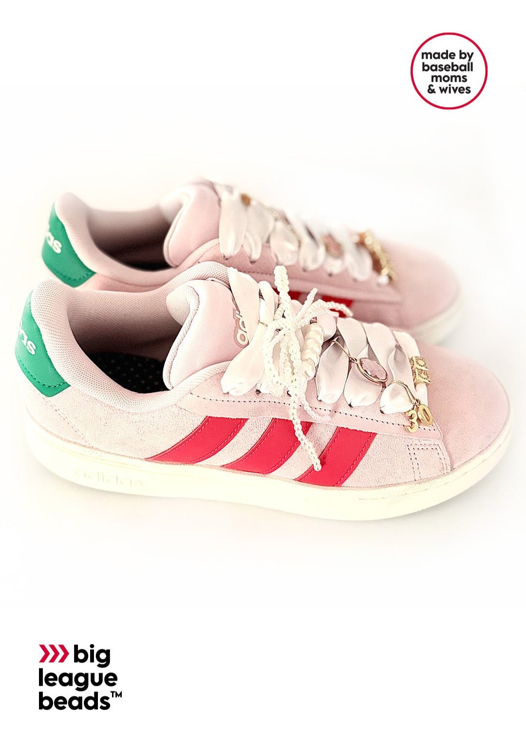 Pink Adidas sneakers with green and red stripes on a white background with big league beads logo