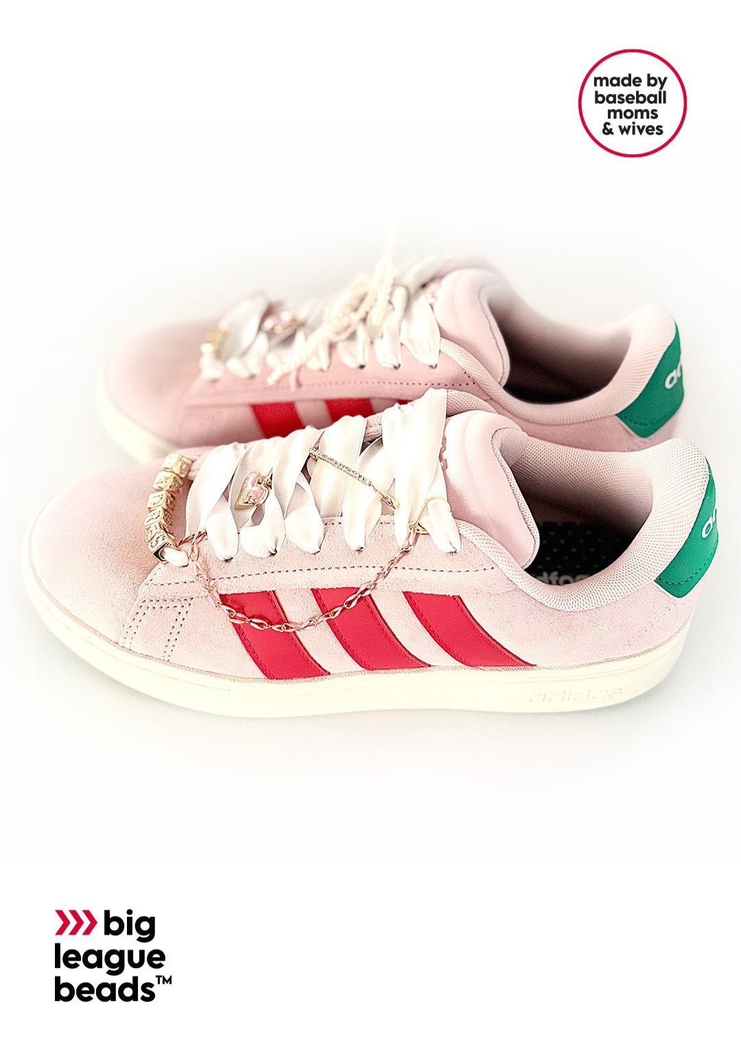 Pink Adidas sneaker with red and green accents on a white background with big league beads logo