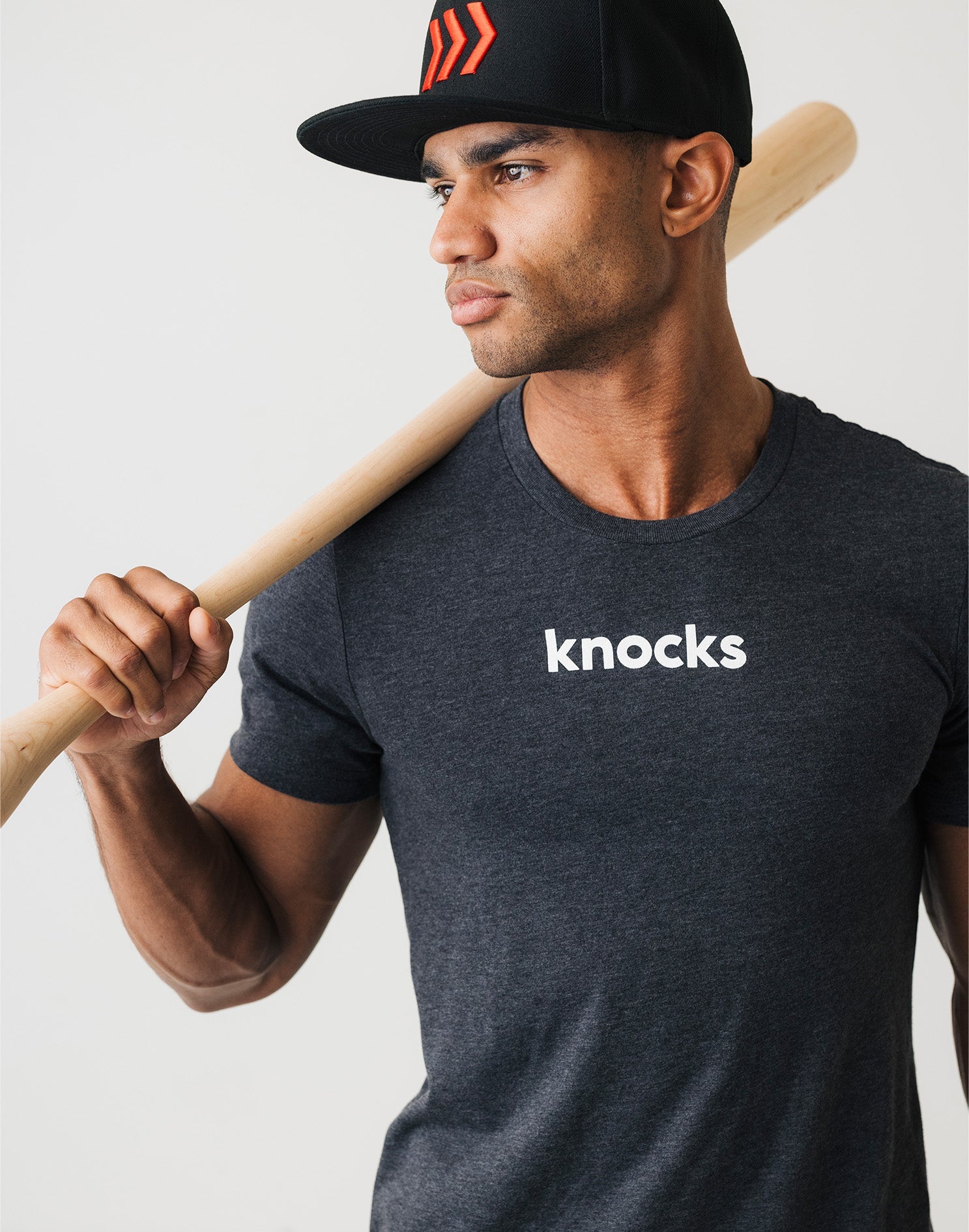 adult-knocks-baseball-tee-on-man
