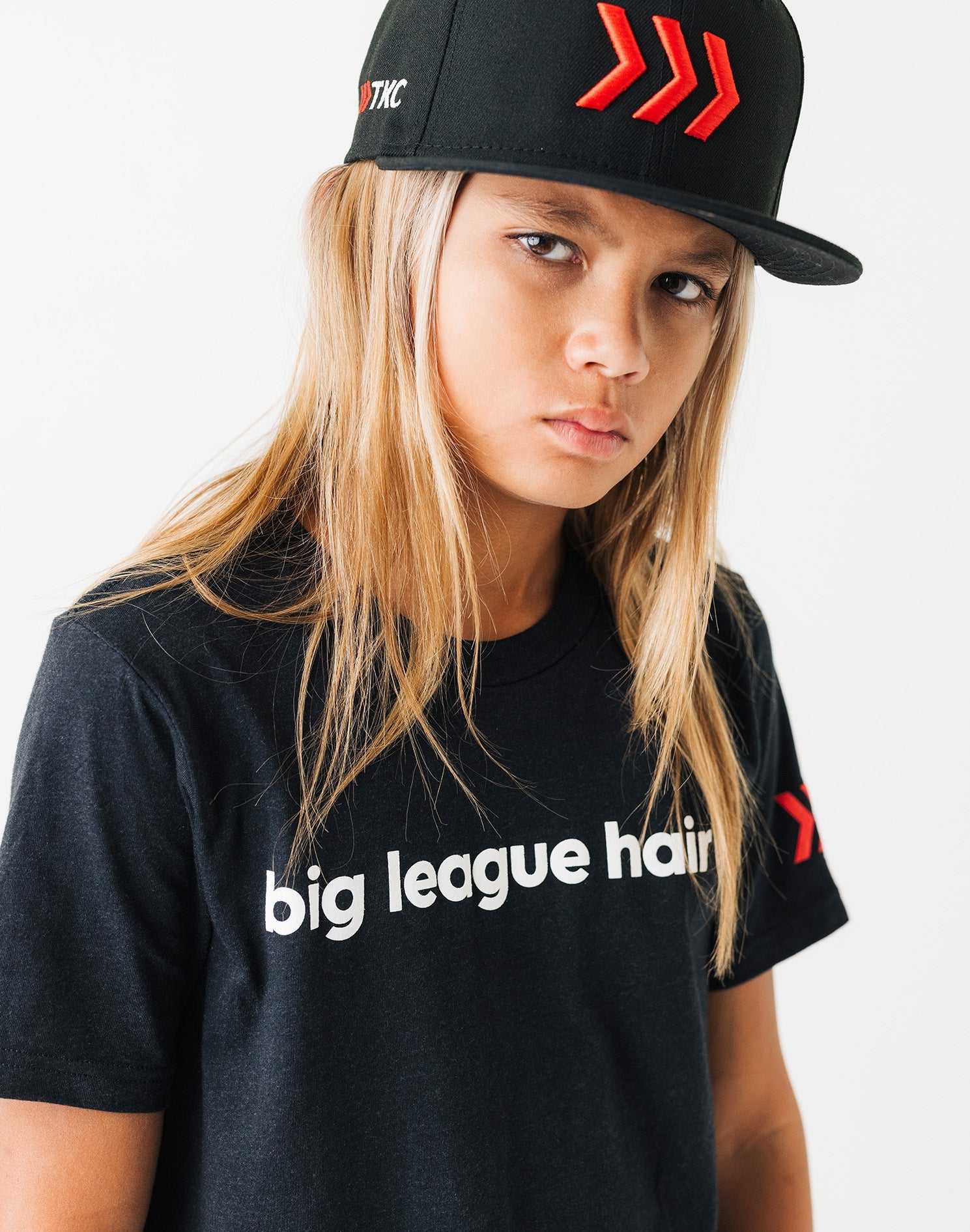 youth-big-league-hair-black-tee-close-up