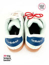 Pair of white Adidas sneakers with red beads on a white background